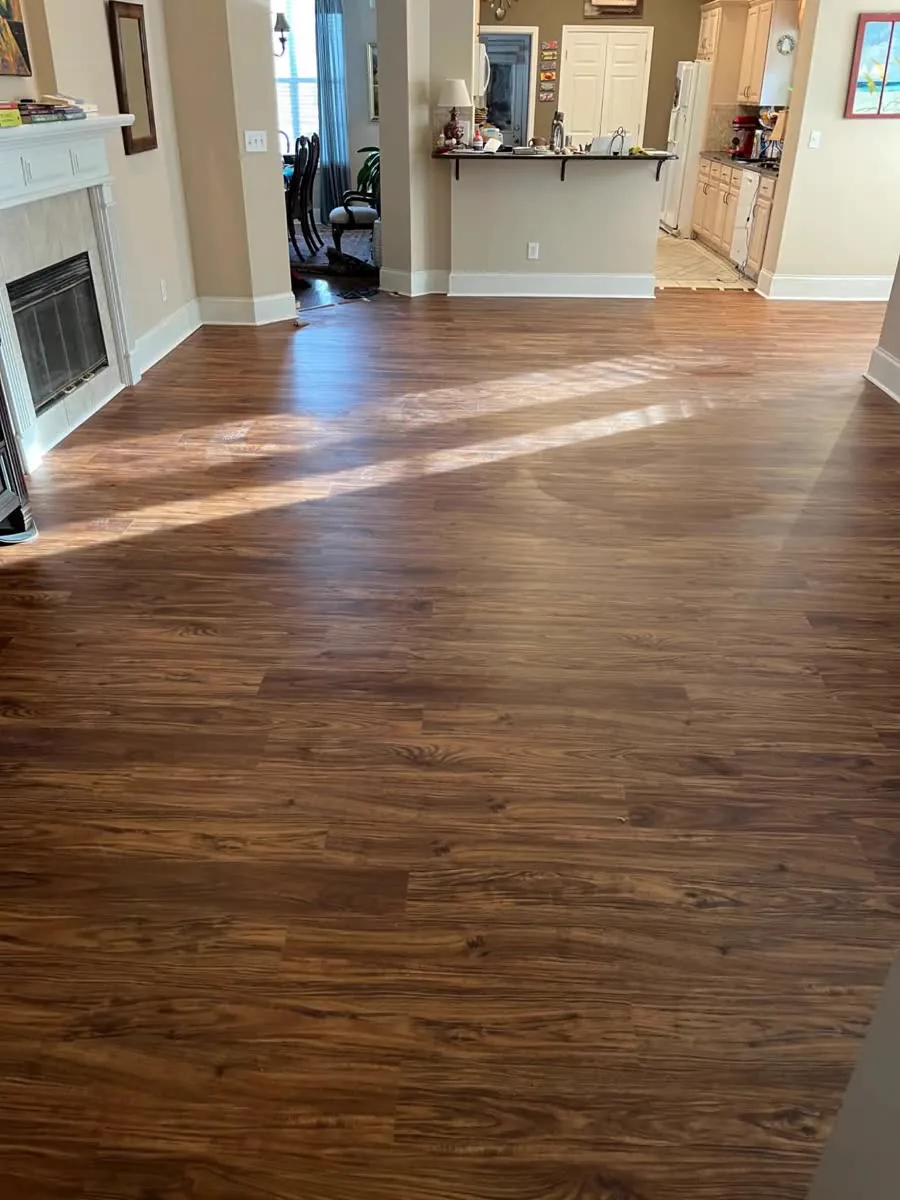 Finished luxury vinyl plank floor around a fireplace in a River Region home