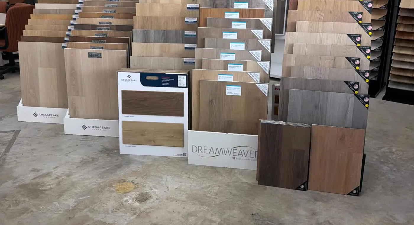 Racks of carpet, vinyl plank and laminate sample boards from several mills